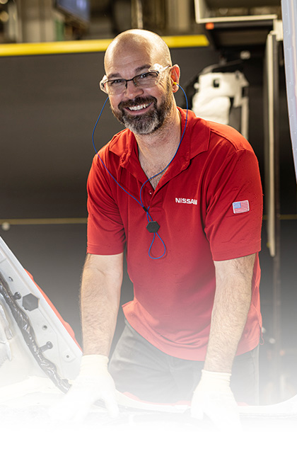 Grinning Nissan factory worker on the job