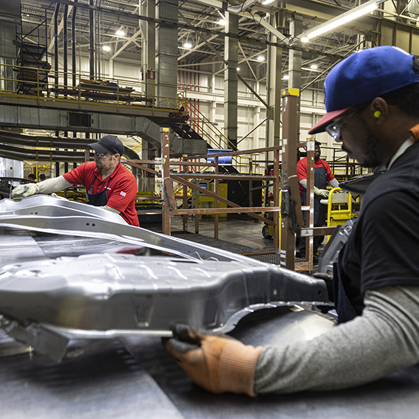 Nissan plant professionals shaping metal parts